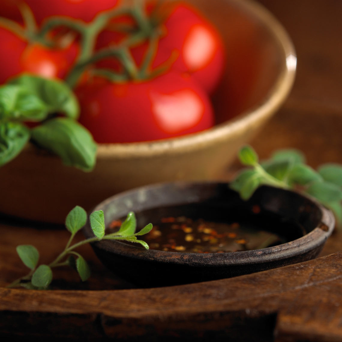 Ramekin/spiced vinaigrette dressing/bowl of tomatoes/food photography