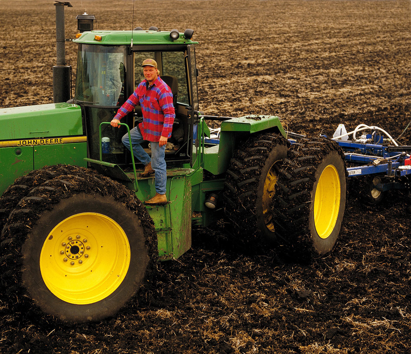 John Deer/Farmer/tractor/plowed field/location agriculture photo